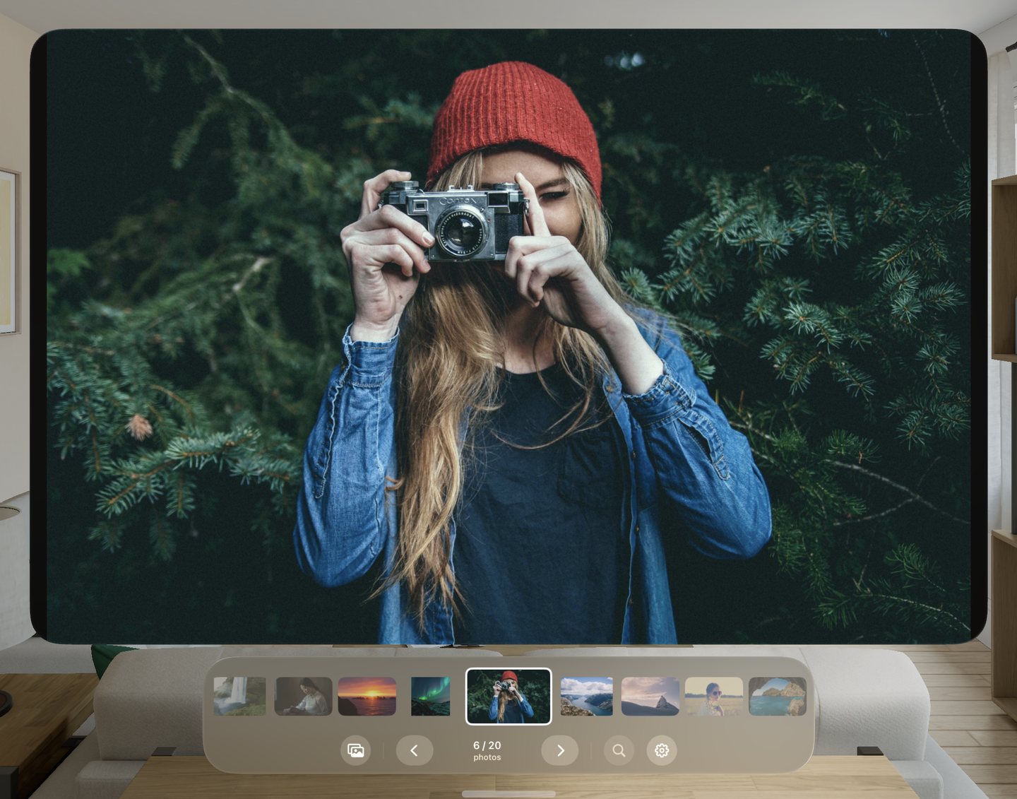A woman in a red hat holding a camera